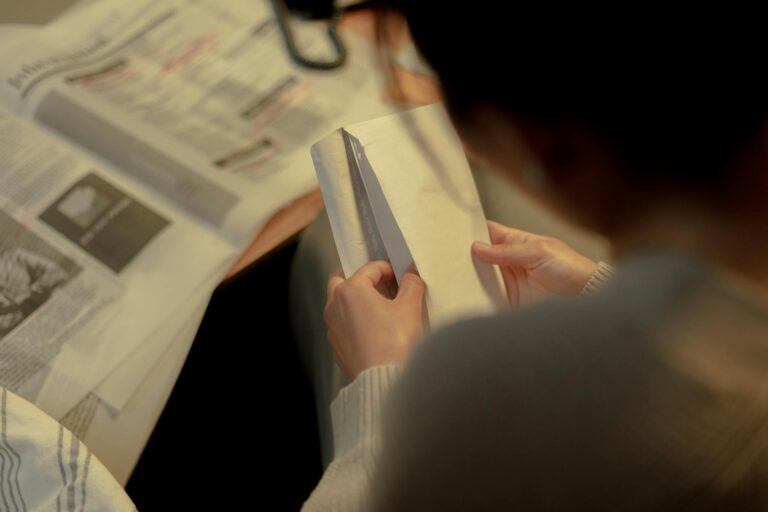 Rear view on woman opening letter