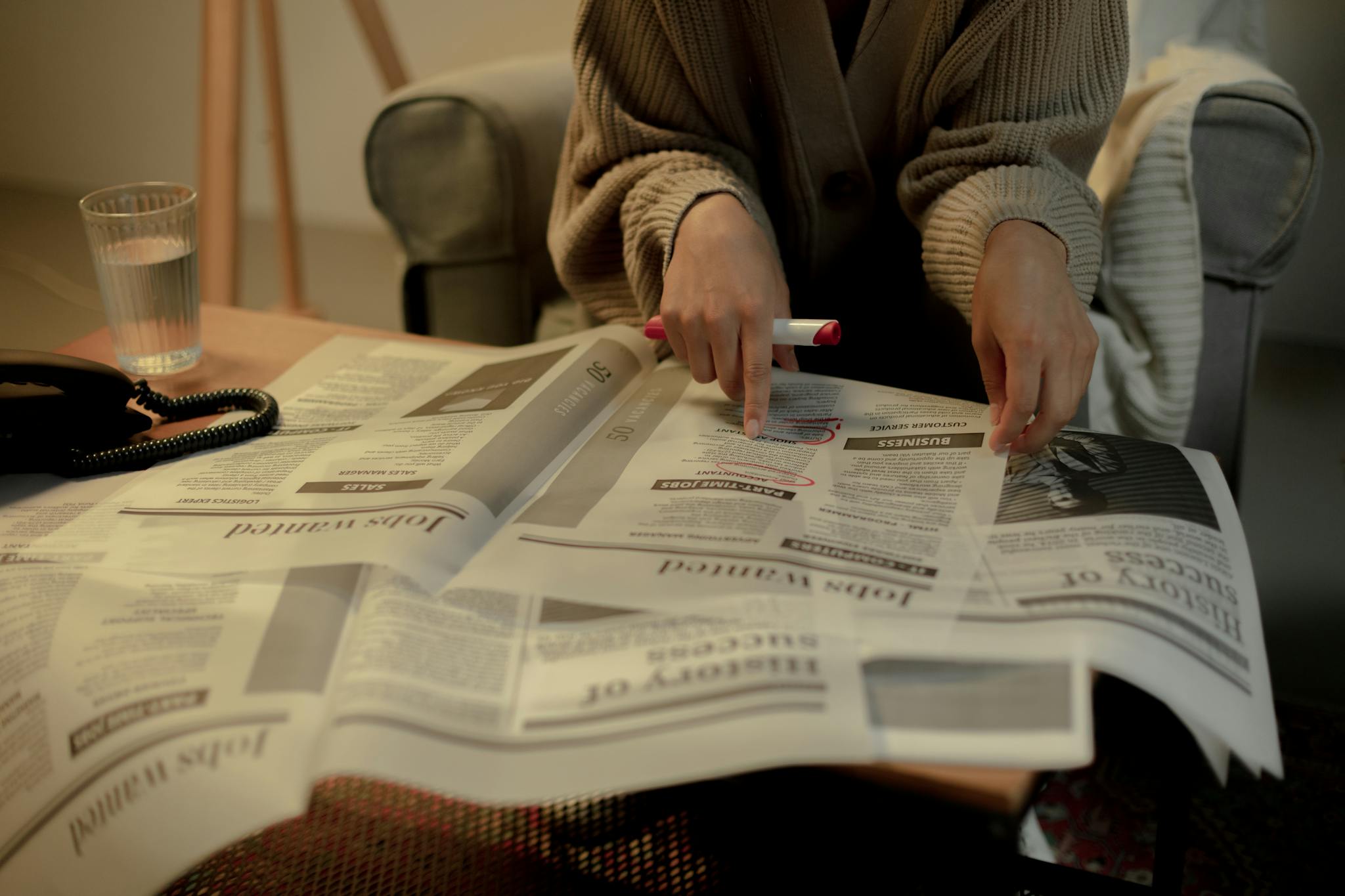 Woman searching job in newspaper